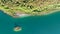 Aerial bright summer evening top-down view of beautiful green waters of a lake