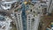 Aerial of builders working in dangerous conditions on top of skyscraper