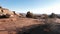 Aerial Camera Movement In Dried Sandy Red Stone Desert With Shrubs And Snags