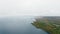 Aerial camera shoots horizon above a lake with a dense forest. Lake Superior, Great Lakes, Ontario, Canada