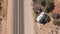 Aerial of camper caravan crashed on a highway accident in a desert rural area. Motorhome crashing event on the motorway