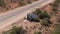 Aerial of camper caravan crashed on a highway accident in a desert rural area. Motorhome crashing event on the motorway