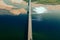 aerial car bridge over river with sandy dunes coast