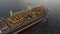 Aerial: Cargo ship in motion with construction equipment on deck