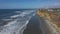 Aerial Carlsbad California beach shore cliff traffic 4K