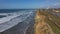 Aerial Carlsbad California surf shore cliff traffic 4K