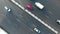 AERIAL: Cars drive through the road. Camera rotating above highway.