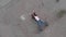 Aerial of Chained trapped woman concept acting like actress showing flag wearing blue jeans and pink t-shirt with a