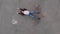 Aerial of Chained trapped woman concept acting like actress showing flag wearing blue jeans and pink t-shirt with a