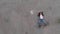 Aerial of Chained trapped woman concept acting like actress showing flag wearing blue jeans and pink t-shirt with a