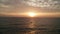 Aerial cinematic shot of sea with boat over beautiful sunset