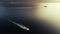 Aerial cinematic view of sailing speedboat, yacht and sailboat. Sunset above the sea in Italy, Monaco, France, Ibiza, Croatia
