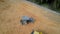 Aerial circle view of the tractor with worker on board at the construction site.