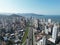 Aerial cityscape with cars, urban buildings by Meia Praia beach in Itapema, Brazil