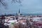 Aerial cityscape view of Tallinn Old Medieval Town on winter day. St. Olaf`s Church spire visible in the distance