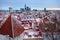 Aerial cityscape view of Tallinn Old Town on winter day. Red rooftops from tiles, Golden Cockerel weathervane, Town Hall spire,