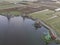 Aerial of classic dutch windmills at the Zaanse Schans with algea in the water