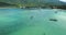 Aerial Clear Water Bay Tropical Beach Coast View. Turquoise Lagoon Surface. Boat Flow Mountain Chain