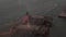 AERIAL: Close up circle flight over Brooklyn Bridge with american flag and foggy Manhattan New York City Skyline