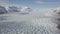 Aerial: Close up of Largest Glacier in Europe Vatnajokull. Beautiful glaciers flow through the mountains in Iceland.