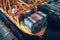 Aerial close up view of a cargo container ship. Fully loaded container ship at the cargo terminal in a seaport, port