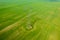 Aerial close-up view of electricity pylon with power lines over agricultural field