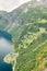 Aerial close-up view of a zig-zag winding road going up a steep slope near Geiranger, Norway