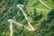 Aerial close-up view of a zig-zag winding road going up a steep slope near Geiranger, Norway