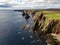 Aerial coastline view of Duncansby Stacks on a partly cloudy day