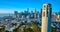 Aerial Coit Tower with San Francisco downtown in background and Oakland Bay Bridge