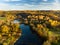 Aerial colorful forest scene in autumn with orange and yellow foliage.