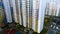 Aerial of construction of apartment buildings in sleeping area of big city. Motion. High rise residential house with