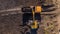 Aerial construction - top down view of an excavator and truck working on a construction site