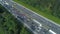 AERIAL: Countless cars and trucks moving through a bottleneck on the freeway.