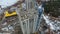 Aerial of crane unloading concrete blocks on top of building