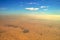 Aerial. Desert. Blue sky above approaching sandstorm.