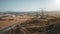 Aerial desert countryside landscape. High voltage power lines over highway road. Electricity supply