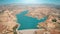 Aerial desert landscape dam blue water reservoir. Top view of dam barrage on azure river