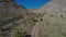 Aerial desert vehicle dirt road follow Utah 4K