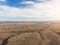 Aerial distant view of group of wind turbines on beautiful sunny mountain landscape. Clean energy power concept. Road through