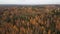 Aerial dolly out view: Small lonely church among autumn trees in countryside in Europe
