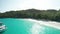 Aerial dolly over emerald water and yacht to Anse Lazio beach, Praslin