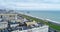 Aerial dolly view of the town of Brighton and Hove towards the beach