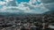 Aerial of downtown Caracas Venezuela, rolling hills, billowing clouds, full sun