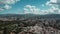 Aerial of downtown Caracas Venezuela, rolling hills, billowing clouds, full sun