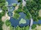 Aerial downward shot of road on the river in Hertfordshire with a weir