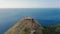 Aerial drone approaching Fort Rodney on top of a mountain in a blue sea at Rodney Bay, Saint Lucia