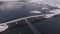 Aerial drone captures the pristine Arctic winter scenery of Lofoten Islands. A car gracefully passes over a sunlit