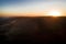 Aerial drone flight, direction Vienna over the Vienna Woods at sunrise