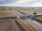 Aerial drone flight over road junction. Top view. Summer highway crossroad